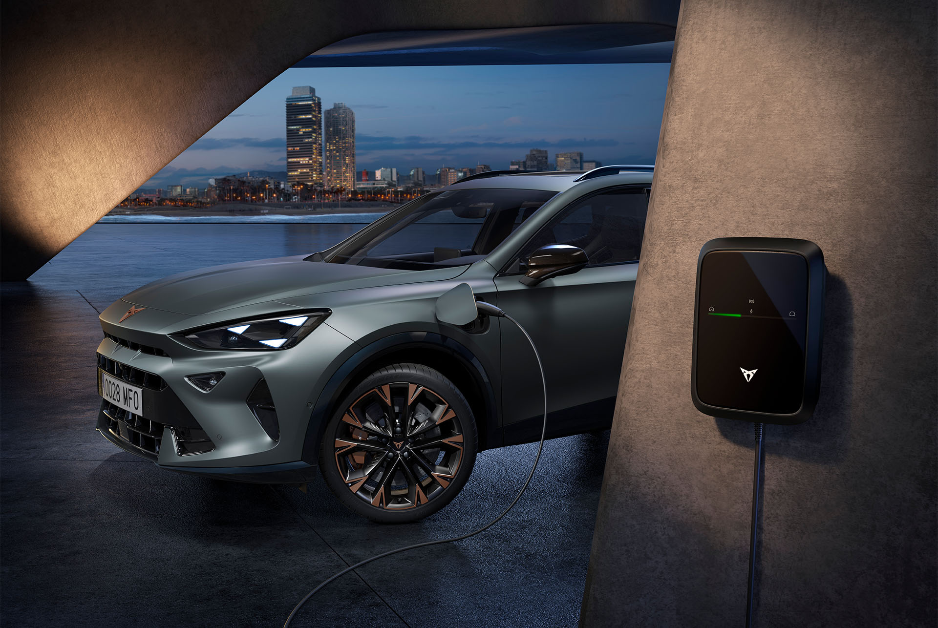 side view of the CUPRA Formentor 2025 in the colour Enceladus Grey matt, parked in an outdoors environment showcasing the car’s charging point.  