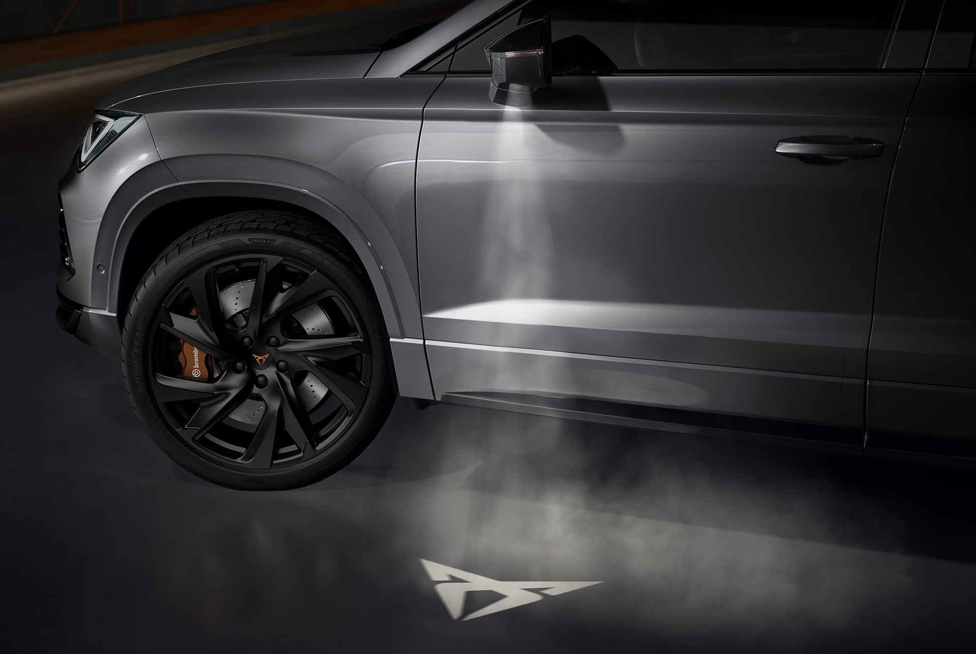 CUPRA logo projected onto the ground from the CUPRA Ateca, representing the connection with the CUPRA Tribe.