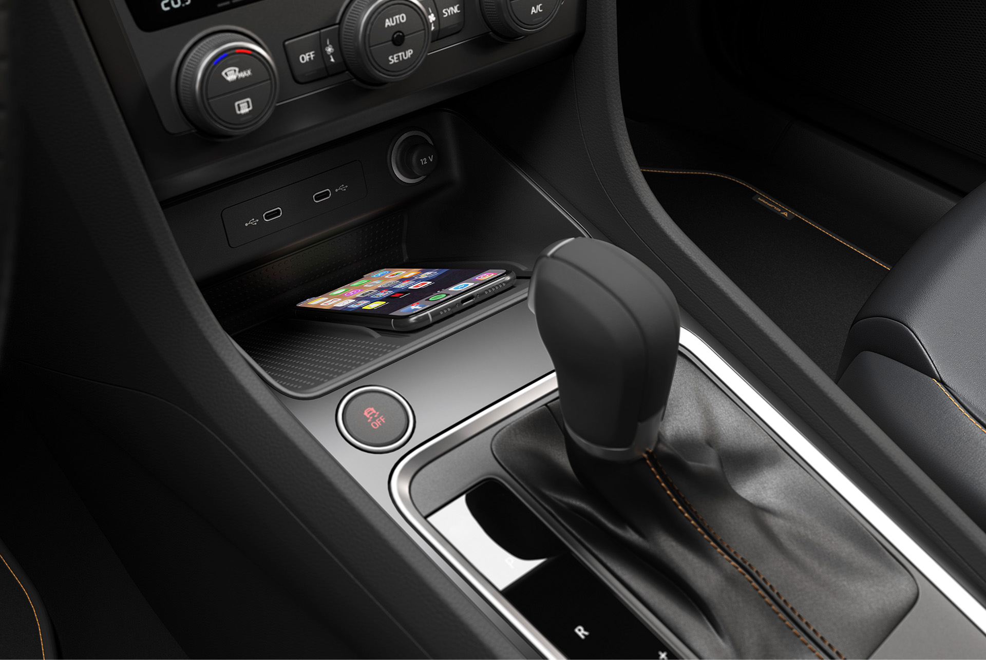 The CUPRA Ateca's Connectivity Box with wireless charging, displaying a smartphone placed on the charging pad near the gear shifter.
