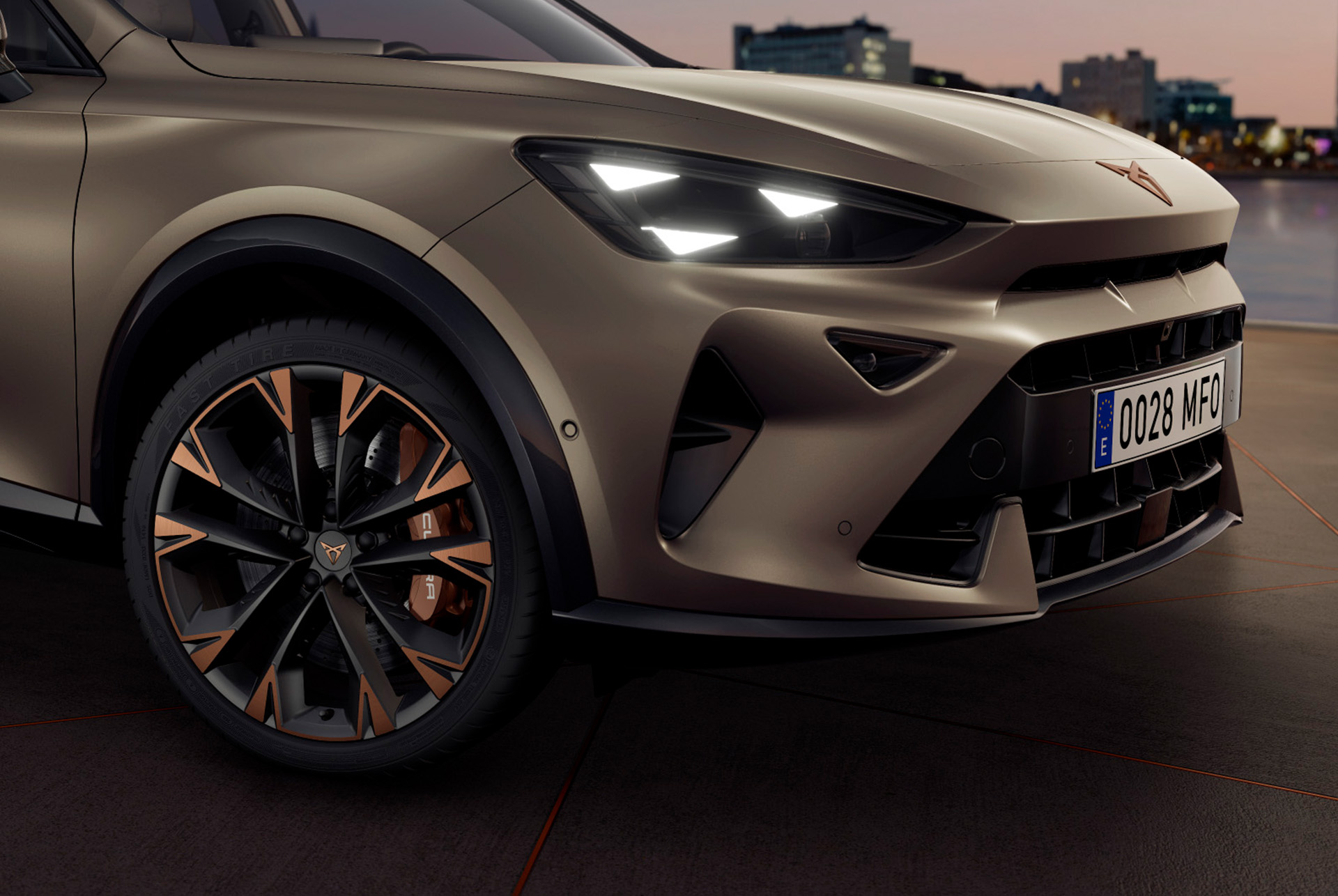 Exterior view of new CUPRA Formentor 2025 copper accent wheels, Akebono brakes, wing mirror, tyres, signature triangle eye LED headlights and CUPRA logo.