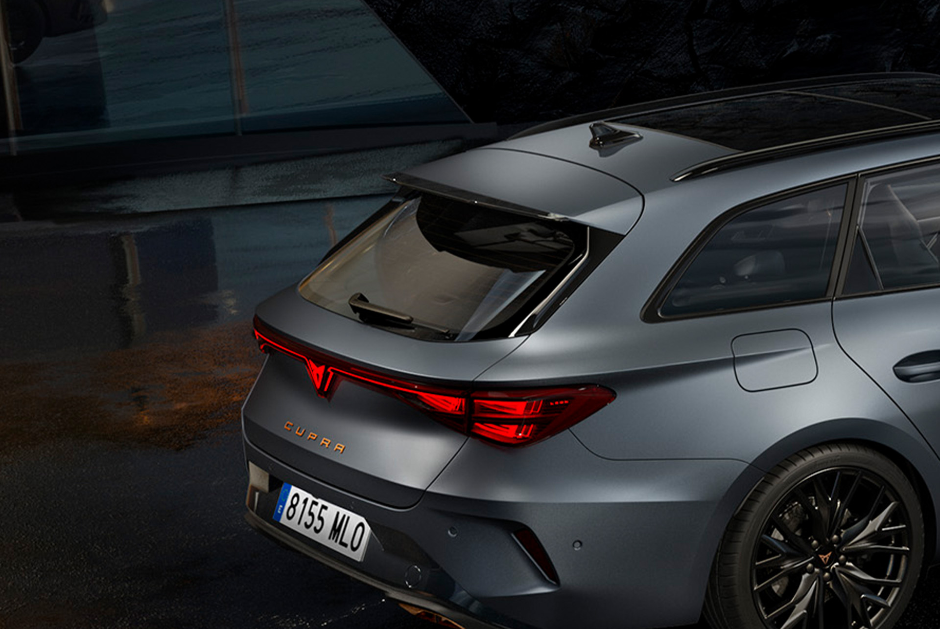 partial rear view of cupra leon sportstourer highlighting the black rear spoiler from the black edition.
