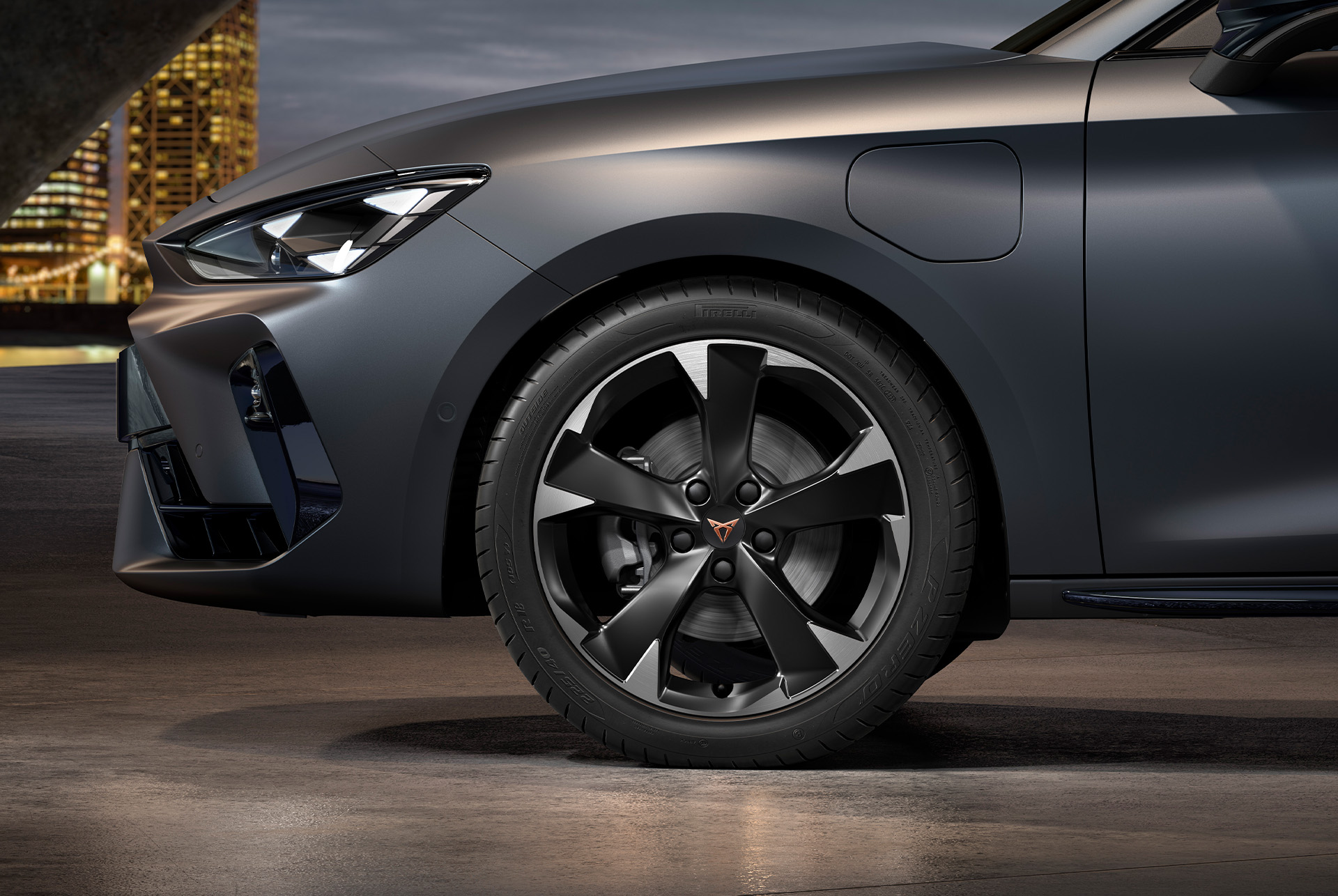 front side view of left machined silver garbi alloy wheel for the cupra leon Sportstourer, tyres, signature headlights and grey body