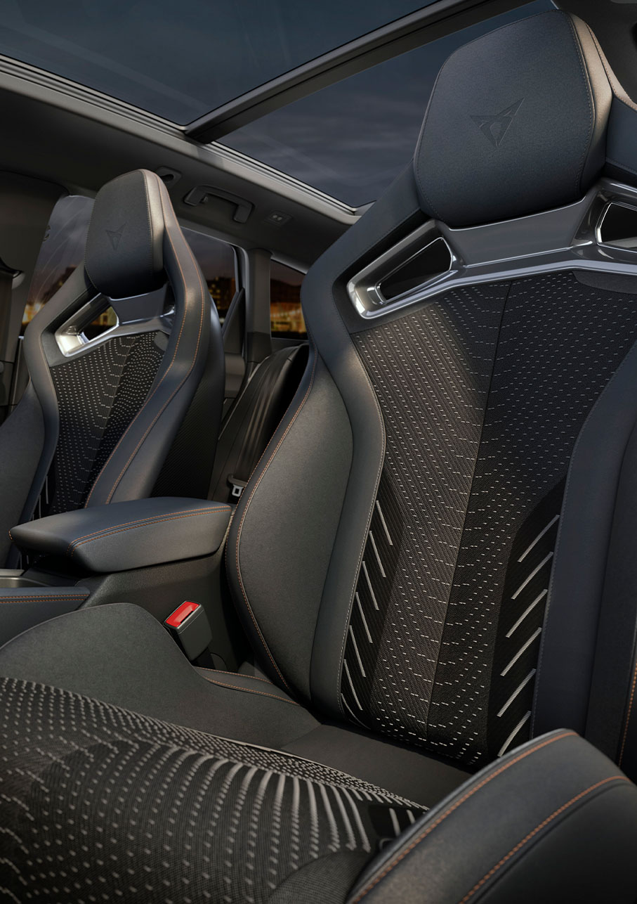 Cupra Leon Sportstourer interior, extreme equipment pack, central console, cup bucket seats, sennheiser speakers and more. Sunset outside of window.