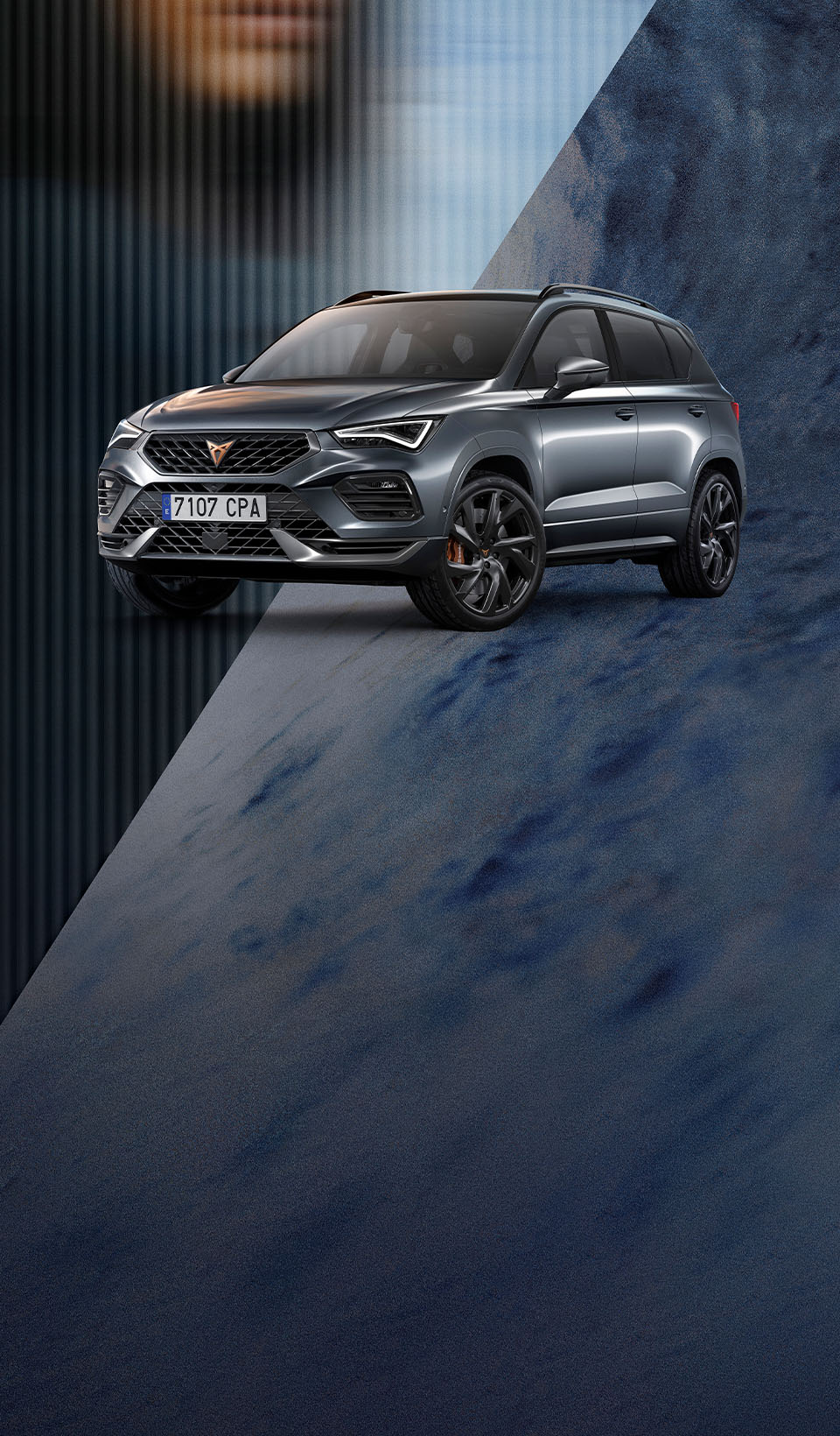 A CUPRA Ateca SUV parked with its front turned slightly towards the viewer, showcasing its distinctive grille, headlights, and copper-accented wheels on blurred background featuring an abstract pattern with a subtly visible human face on the left side.