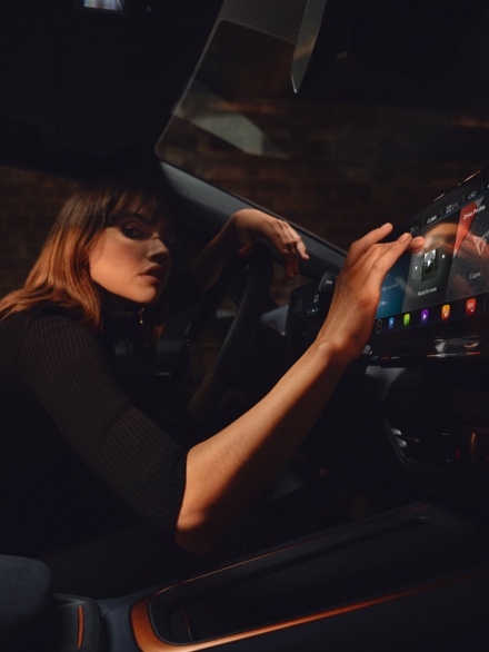 Woman using CUPRA dashboard infotainment screen