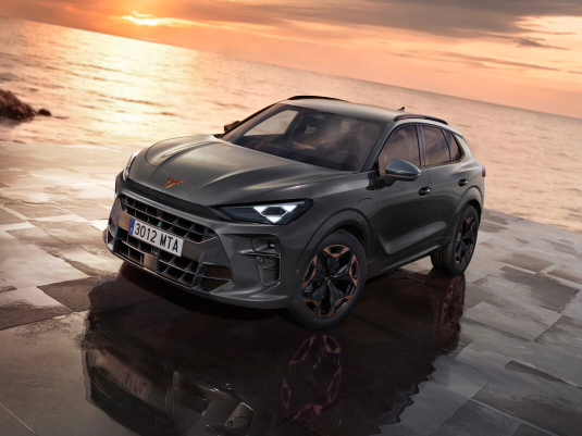 Cupra terramar suv in timanfaya grey, model year 2025, with 19 inch cosmic copper wheels at sunset by the sea. Hybrid suv for sale.