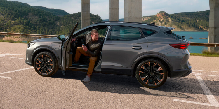 cupra formentor and man wating to received roadside assistance for electric and hybrid cars