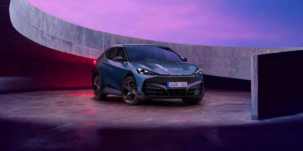 Cost of running an electric car vs petrol in the UK — CUPRA Tavascan VZ in Tavascan Blue, 3/4 front view in a futuristic urban setting.